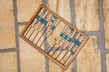 Old abacus on a stone wall