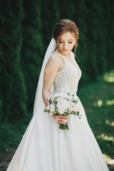 Portrait of stunning bride with long hair posing with great bouquet