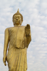 the gold buddha statue stand and show his hand
