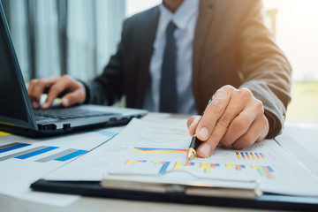 Business people partner negotiating a contract, they are pointing on a document and discussing together,Two businessmen are negotiating in office.