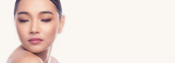 Fototapeta premium Beautiful Young Asian Woman with Clean Fresh Skin isolate on white background. Spa, Face care, Facial treatment, Beauty and Cosmetics concept. Chin on right shoulder, eye close. Banner frame.
