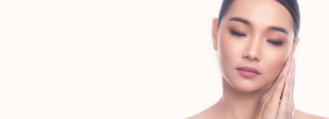 Fototapeta premium Beautiful Young Asian Woman with Clean Fresh Skin isolate on white background. Spa, Face care, Facial treatment, Beauty and Cosmetics concept. Sleeping beauty, eye close. Banner frame.