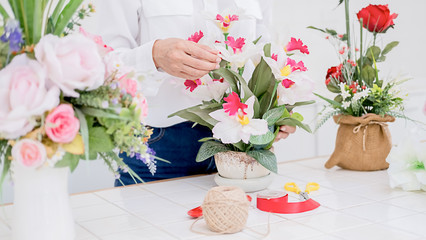 Flower shop staff arrange flowers as ordered for valentines.