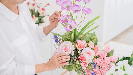 Flower shop staff arrange flowers as ordered for valentines.