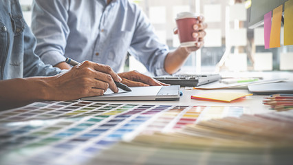 Graphic design and color swatches and pens on a desk. Architectural drawing with work tools and...