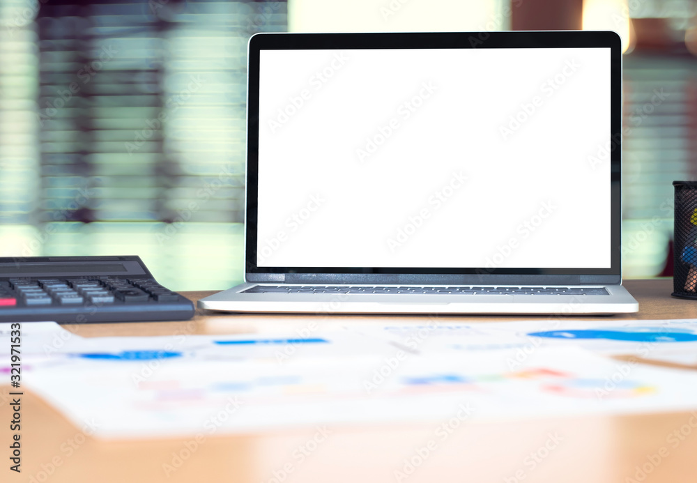 Poster mockup laptop computer screen with business chart market,caculator on desk at blur modern office .de