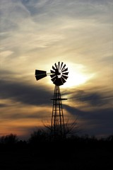 Kansas Windmill at Sunset with a colorful sky out in the country north of Hutchinson Kansas USA.