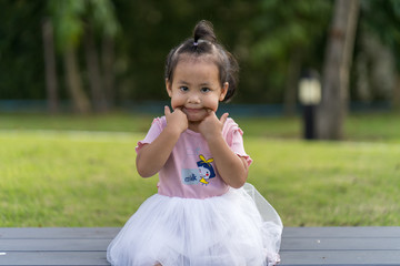 Cut little girl playing at park in summer.