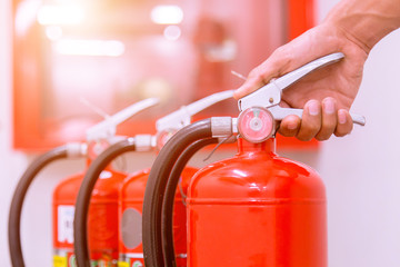 Close up Fire extinguisher and pulling pin on red tank.