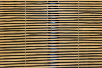 A close-up of wooden oriental jalousie blinds over a window (texture/background/pattern)