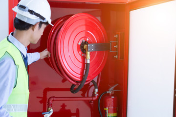 Engineer inspection Fire extinguisher and fire hose. - obrazy, fototapety, plakaty