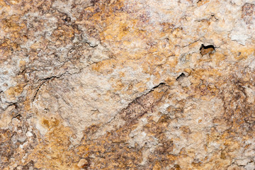 A grunge texture background of an old  stone relief wall