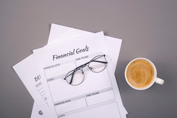 Modern methods of conducting financial accounting and education of financial discipline. Printouts to control accumulations on a gray desktop. Background with copy space.