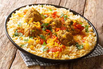 Afghan meat balls in spicy sauce with yellow peas served with basmati rice close-up in a plate. horizontal