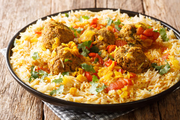 Kofta Chalao Stewed meat balls in spicy sauce with yellow peas served with basmati rice close-up in a plate. horizontal