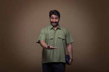 Man holding a small bag in one hand and looking at his palm in surprise.