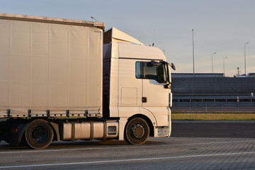 Side view of a truck standing for rest at parking lot.