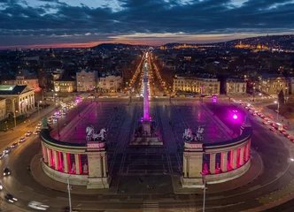 Muurstickers Budapest, Hungary - Aerial drone view of the famous Heroes' Square (Hosok tere) lit up in unique purple and pink color by night with a colorful sunset © zgphotography