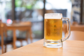 Glass of beer on wooden table