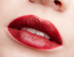 Closeup macro portrait of female red smiling lips with day beauty makeup.