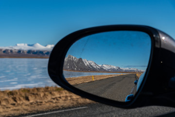 Beautiful view of mountains seen on the side mirror in Iceland