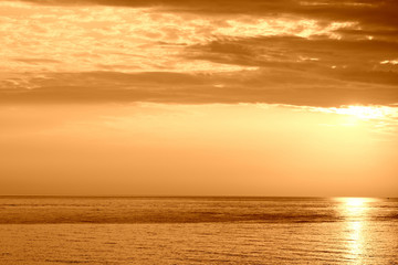Fototapeta premium Beautiful sunrise over the sea near the coast of Sicily. Natural background orange color toned