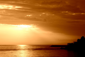 Fototapeta na wymiar Beautiful sunrise over the sea near the coast of Sicily. Natural background orange color toned