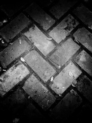 Abstract grunge paving stones texture. use as a background or wallpaper. black and white, so contrast and grainy.