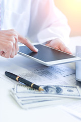 Fototapeta premium Businessman with cash dollars - business concept,tablet and finance,investment,save.