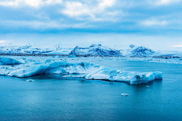 Blue Icebergs floating in beautiful Jokulsarlon lagoon Iceland