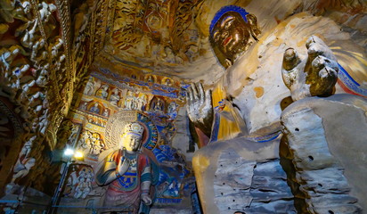 Old statue inside a cave. Seated buddha in Yungang Grottoes  near Datong, Shanxi Province, China