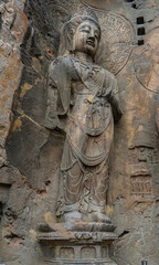 Fototapeta na wymiar Big statue made in limestone of bodhisattvas. The main cave (Fengxiangsi Cave) of Longmen Grottoes in Luoyang . A world heritage Site in Henan province, China. 
