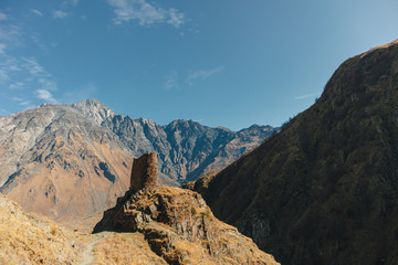 Fototapeta premium Landscape of Gergeti tower ruins on mount Kazbek trail in Stepansminda, Kazbegi, Georgia.
