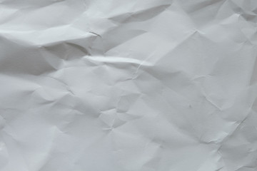 Wrinkled white blank plain paper with shade of light and shadow. Ideal for background or wall wallpaper with copy space for text.