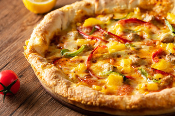 whole italian pizza on wood table with ingredients