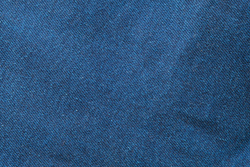 Selective focus blue jean denim top view close up shot to the detail of fabric. textile material and cotton patter tough and durable garment style. For background or wallpaper with copy space for text