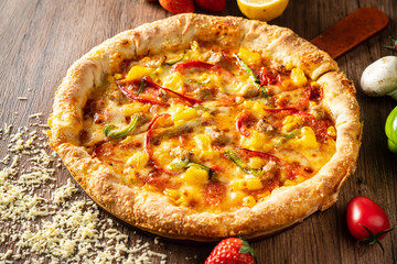 whole italian pizza on wood table with ingredients
