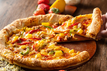 whole italian pizza on wood table with ingredients