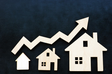 Property invest and rising of worth concept. Small houses and arrow.
