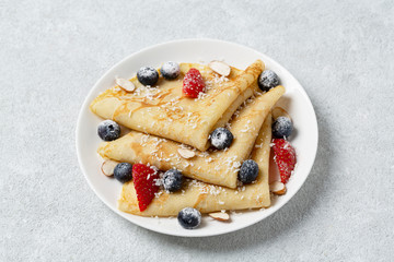 Delicious pancakes with fresh strawberries and blueberries. Sweet pancakes for Breakfast