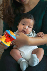 Baby plays with the toy that make sound