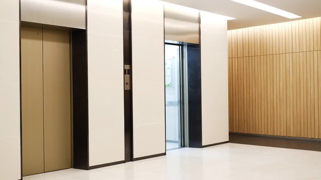 Modern steel elevator cabins in a business lobby or Hotel, Store, interior, office,perspective wide angle. Three elevators in hotel lobby.