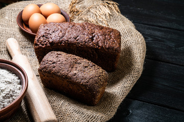 Mixed breads on dark stone table. Top view with copy space