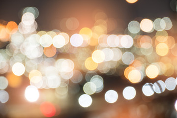 Fototapeta premium Defocused city night filtered bokeh abstract background. Bokeh background texture.