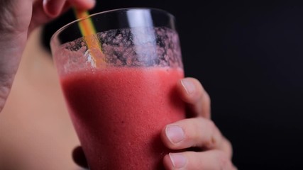Pretty woman drinking strawberry smoothie from straw  - Powered by Adobe