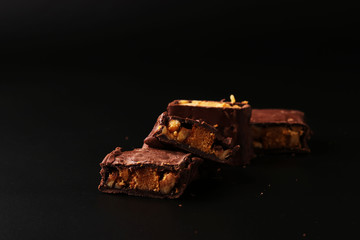Italian chocolate with biscuit and nuts on a black background