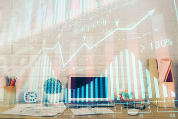 Financial graph colorful drawing and table with computer on background. Double exposure. Concept of international markets.