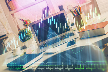 Double exposure of graph and financial info and work space with computer background. Concept of...