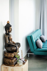 bronze buddha statue interior design detail in modern asian home