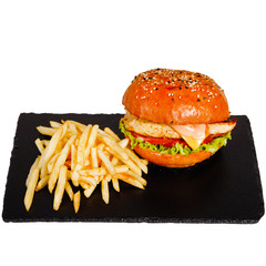 Tasty Burger and French fries on a plate in cafe.